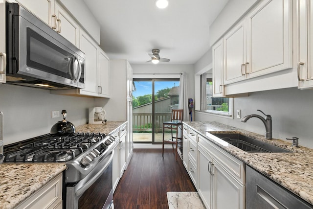 2S404 Emerald Green Dr Unit 44-H, Warrenville, IL 60555 - kitchen featuring appliances with stainless steel finishes, a ceiling fan, white cabinets, light stone counters, and dark wood-style floors