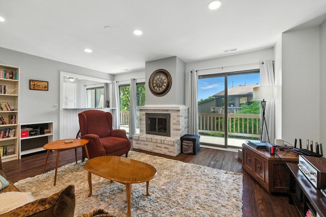 2S404 Emerald Green Dr Unit 44-H, Warrenville, IL 60555 - living room with healthy amount of natural light, a brick fireplace, wood finished floors, and recessed lighting