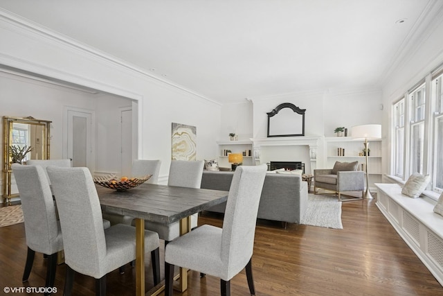 3120 N Sheridan Rd Unit A1, Chicago, IL 60657 - dining room with healthy amount of natural light, crown molding, dark wood-type flooring, and a warm lit fireplace