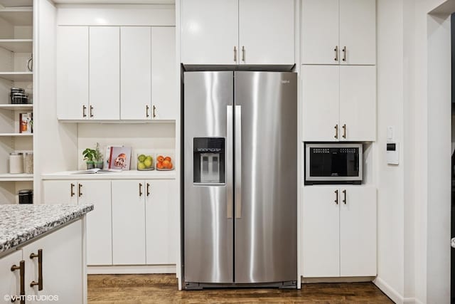 3120 N Sheridan Rd Unit A1, Chicago, IL 60657 - kitchen featuring stainless steel refrigerator with ice dispenser, open shelves, dark wood-style floors, white cabinets, and built in microwave