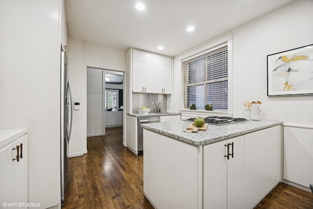 3120 N Sheridan Rd Unit A1, Chicago, IL 60657 - kitchen featuring a peninsula, white cabinetry, appliances with stainless steel finishes, dark wood-type flooring, and recessed lighting