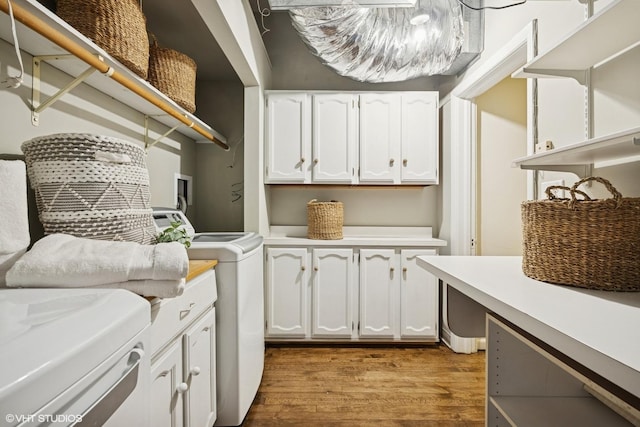 3120 N Sheridan Rd Unit A1, Chicago, IL 60657 - laundry area featuring cabinet space, wood finished floors, and independent washer and dryer