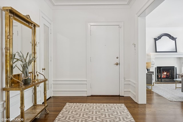 3120 N Sheridan Rd Unit A1, Chicago, IL 60657 - foyer entrance featuring dark wood-style flooring, ornamental molding, and a lit fireplace