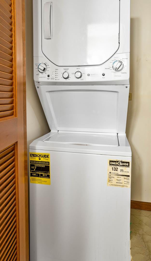 13750 S Bristlecone Dr Unit 408, Plainfield, IL 60544 - laundry room with stacked washer / dryer, marble finish flooring, and baseboards