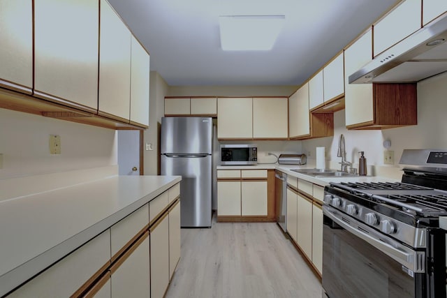 13750 S Bristlecone Dr Unit 408, Plainfield, IL 60544 - kitchen featuring appliances with stainless steel finishes, under cabinet range hood, light countertops, and light wood finished floors