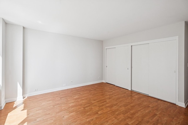 1550 N Lake Shore Dr Unit 7D, Chicago, IL 60610 - unfurnished bedroom featuring light wood finished floors, baseboards, and a closet