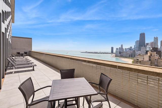 1550 N Lake Shore Dr Unit 7D, Chicago, IL 60610 - balcony featuring a water view, a view of skyline, and outdoor dining space