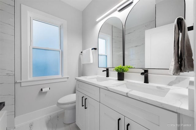 4846 W Roscoe St, Chicago, IL 60641 - full bath with marble look tile flooring, double vanity, toilet, and baseboards
