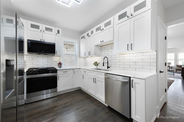 4846 W Roscoe St, Chicago, IL 60641 - kitchen with appliances with stainless steel finishes, a sink, and white cabinetry