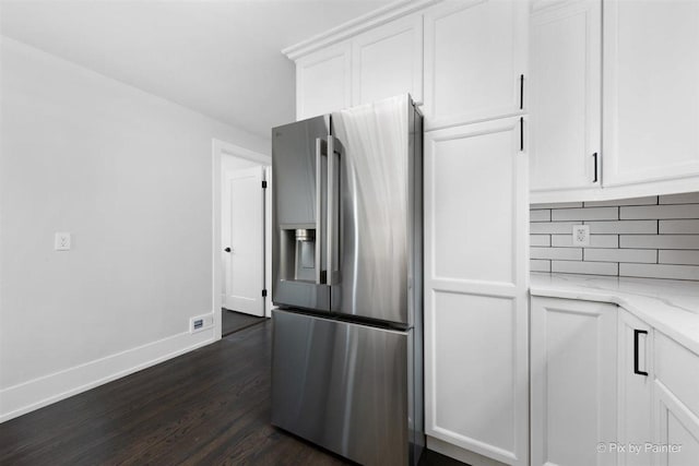 4846 W Roscoe St, Chicago, IL 60641 - kitchen featuring stainless steel fridge, dark wood-style floors, decorative backsplash, and white cabinets