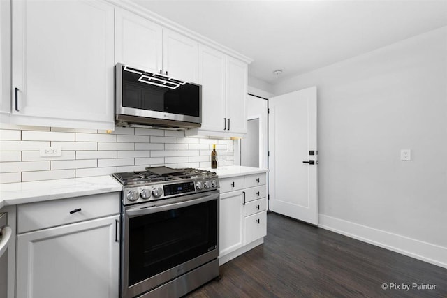 4846 W Roscoe St, Chicago, IL 60641 - kitchen with stainless steel appliances, dark wood-style floors, backsplash, baseboards, and white cabinetry
