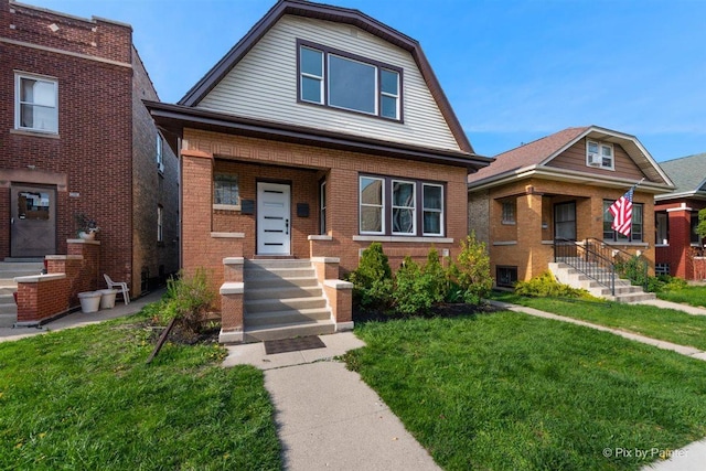 4846 W Roscoe St, Chicago, IL 60641 - view of front facade with a gambrel roof, brick siding, and a front lawn