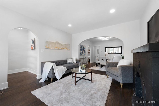 4846 W Roscoe St, Chicago, IL 60641 - living area featuring arched walkways, wood finished floors, a fireplace, baseboards, and recessed lighting