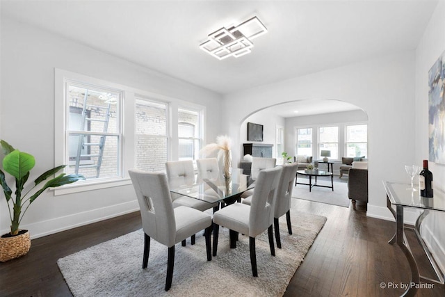 4846 W Roscoe St, Chicago, IL 60641 - dining space with arched walkways, baseboards, and wood finished floors