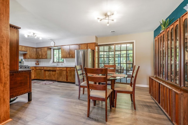 480 W Kennedy Rd, Braidwood, IL 60408 - dining area featuring light wood-style flooring, a chandelier, and baseboards