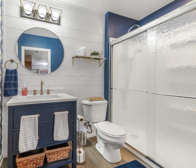 480 W Kennedy Rd, Braidwood, IL 60408 - full bathroom featuring wood finished floors, a shower stall, toilet, and vanity