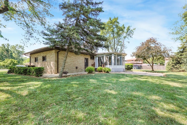 480 W Kennedy Rd, Braidwood, IL 60408 - back of house with a sunroom and brick siding