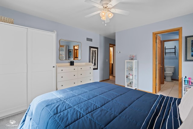 1245 W Lotus Ln, Kankakee, IL 60901 - bedroom featuring a ceiling fan, connected bathroom, baseboards, a closet, and light tile patterned floors