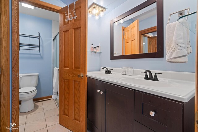 1245 W Lotus Ln, Kankakee, IL 60901 - full bathroom featuring tile patterned flooring, double vanity, toilet, and a shower