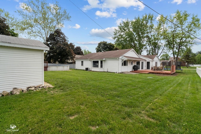 1245 W Lotus Ln, Kankakee, IL 60901 - rear view of house featuring a wooden deck and an outdoor pool