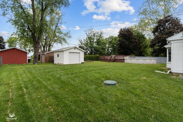 1245 W Lotus Ln, Kankakee, IL 60901 - view of yard featuring an outbuilding, a detached garage, and a deck