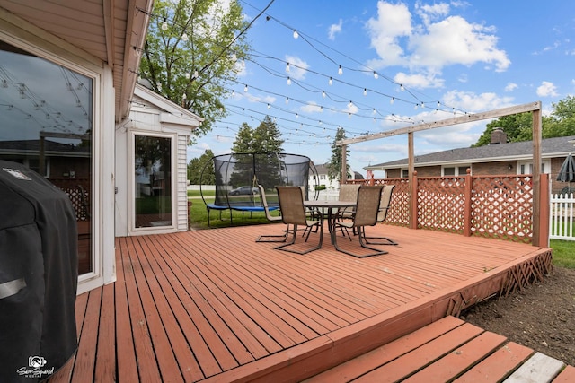 1245 W Lotus Ln, Kankakee, IL 60901 - deck featuring a trampoline, area for grilling, and outdoor dining area