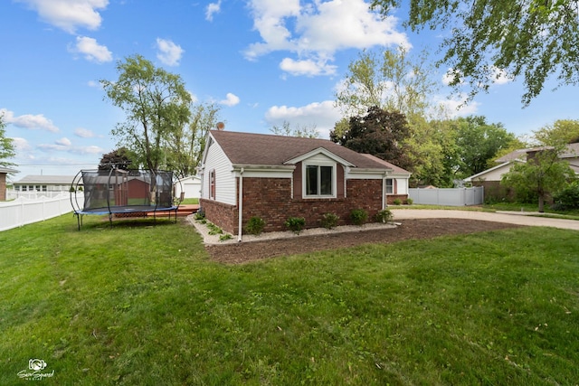 1245 W Lotus Ln, Kankakee, IL 60901 - view of property exterior with a trampoline and brick siding