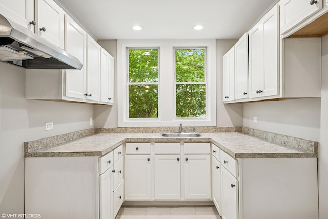 1310 Larkin Ave, Elgin, IL 60123 - kitchen with a sink, under cabinet range hood, light countertops, white cabinetry, and recessed lighting