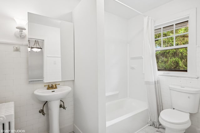 1310 Larkin Ave, Elgin, IL 60123 - full bathroom featuring radiator, tile walls, toilet, and shower / bath combo