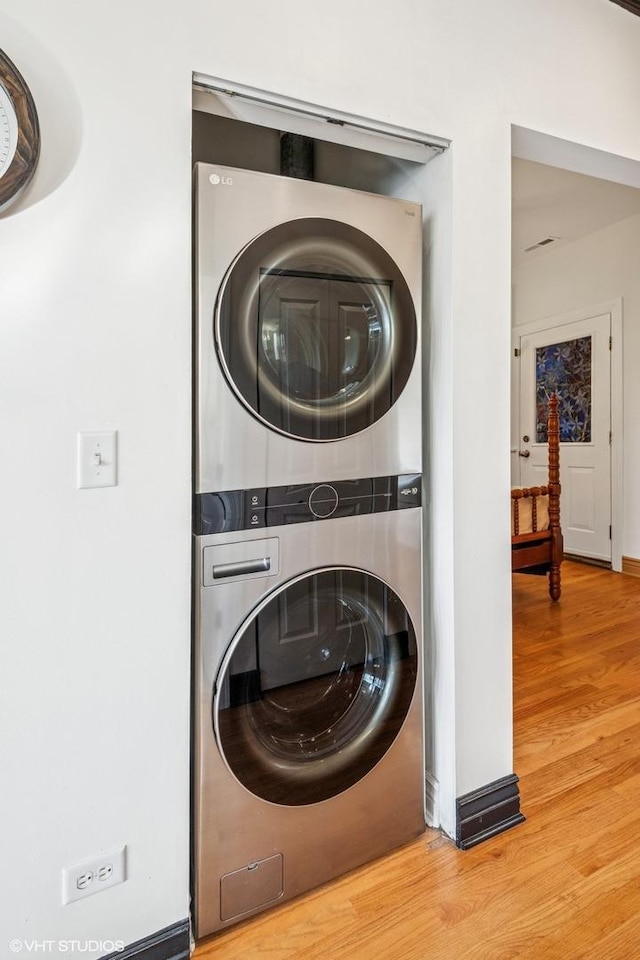 4337 N Troy St Unit 3W, Chicago, IL 60618 - laundry room with stacked washer / dryer and wood finished floors