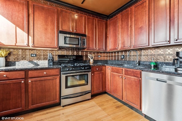 4337 N Troy St Unit 3W, Chicago, IL 60618 - kitchen with appliances with stainless steel finishes, a sink, tasteful backsplash, and dark stone countertops