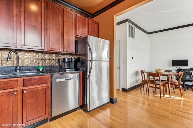 4337 N Troy St Unit 3W, Chicago, IL 60618 - kitchen featuring stainless steel appliances, a sink, crown molding, light wood finished floors, and tasteful backsplash