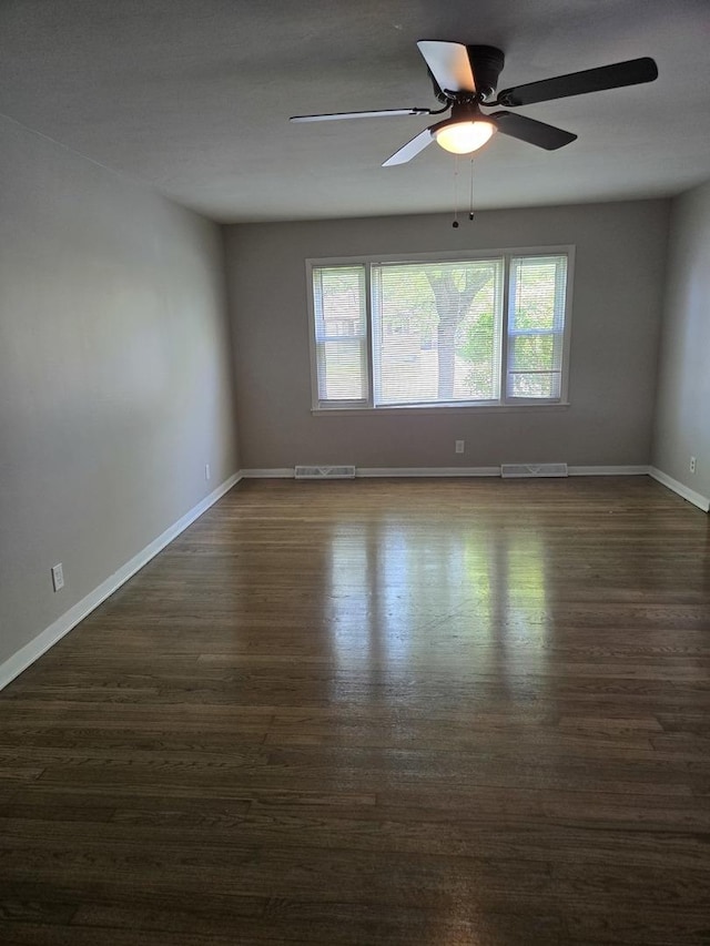 17506 Bernadine St, Lansing, IL 60438 - empty room featuring healthy amount of natural light, dark wood-style flooring, baseboards, and a ceiling fan