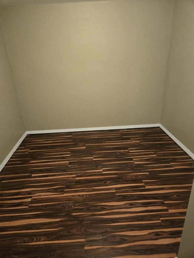 17506 Bernadine St, Lansing, IL 60438 - empty room featuring baseboards and dark wood-style flooring