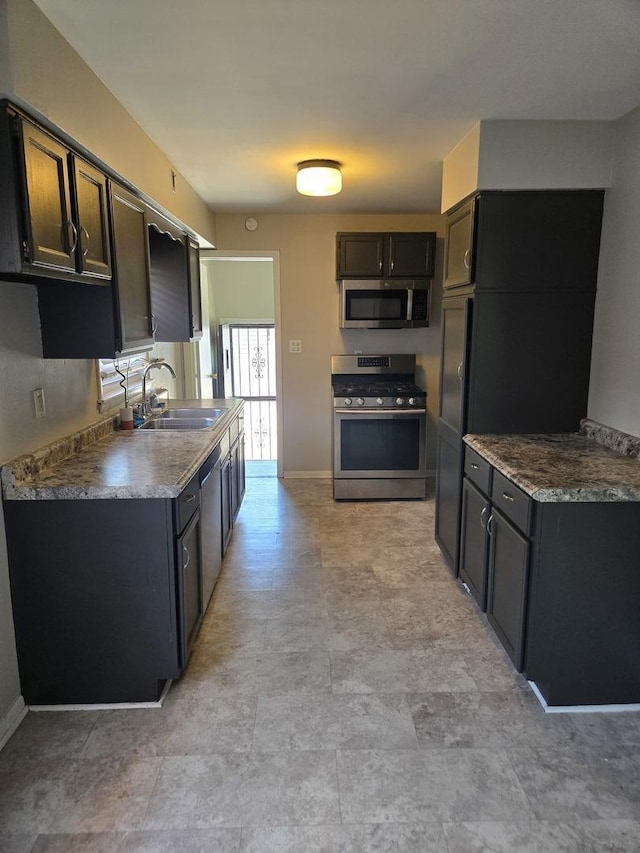 17506 Bernadine St, Lansing, IL 60438 - kitchen featuring appliances with stainless steel finishes, a sink, and baseboards