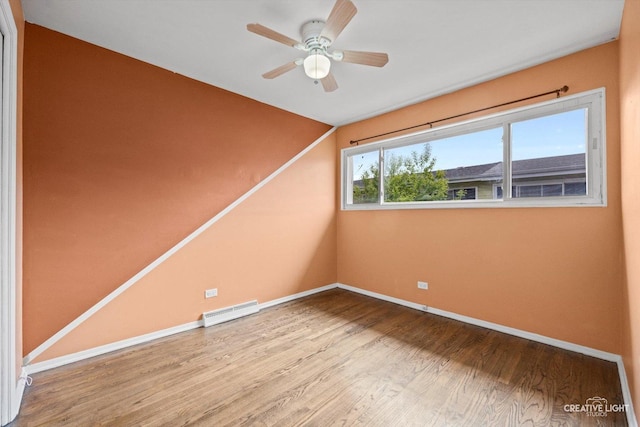8044 W Lyons St Unit B, Niles, IL 60714 - unfurnished room with wood finished floors, a baseboard radiator, baseboards, ceiling fan, and lofted ceiling