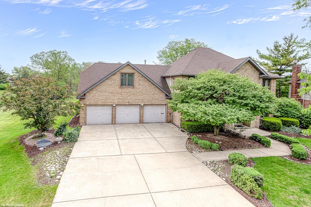 18633 Swan Dr, Mokena, IL 60448 - view of front of house with brick siding, driveway, a shingled roof, and a front lawn