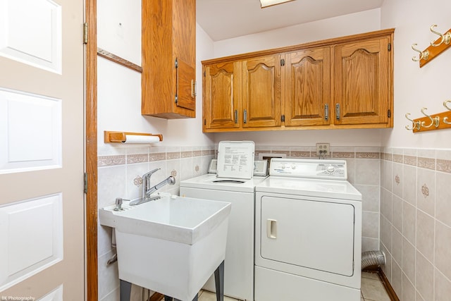 18633 Swan Dr, Mokena, IL 60448 - laundry area featuring tile walls, cabinet space, washing machine and clothes dryer, and a wainscoted wall