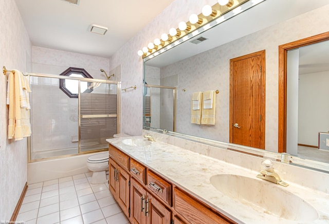 18633 Swan Dr, Mokena, IL 60448 - full bath with tile patterned floors, double vanity, combined bath / shower with glass door, toilet, and baseboards