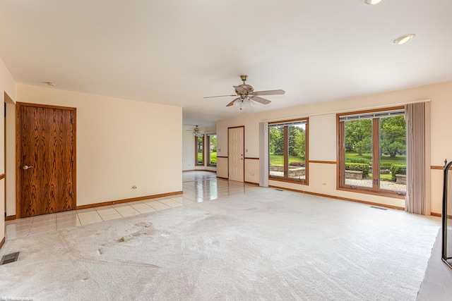18633 Swan Dr, Mokena, IL 60448 - unfurnished living room featuring a ceiling fan, light tile patterned flooring, baseboards, and light colored carpet