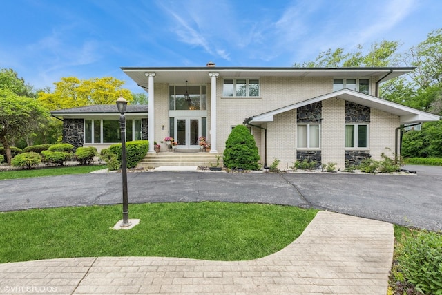 69 Graymoor Ln, Olympia Fields, IL 60461 - view of front of house featuring brick siding, a front yard, and french doors