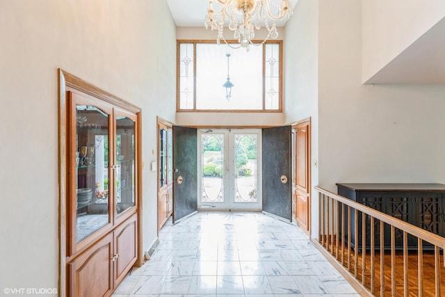 69 Graymoor Ln, Olympia Fields, IL 60461 - foyer featuring french doors, a chandelier, a towering ceiling, and light marble finish floors