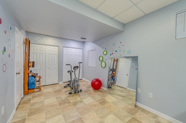 3368 Charlemaine Dr, Aurora, IL 60504 - workout room featuring baseboards, stone finish floors, and lofted ceiling