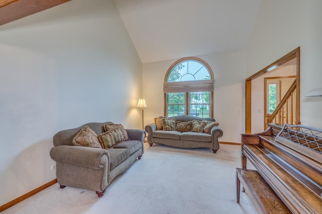 3368 Charlemaine Dr, Aurora, IL 60504 - living area featuring light colored carpet, high vaulted ceiling, and baseboards