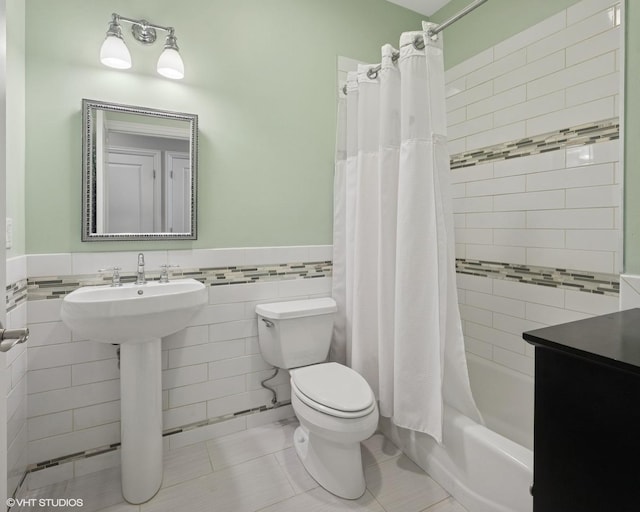 5051 N Clark St Unit 2S, Chicago, IL 60640 - full bath with tile walls, a wainscoted wall, shower / tub combo with curtain, and tile patterned floors