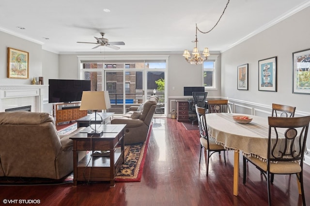 5051 N Clark St Unit 2S, Chicago, IL 60640 - living area featuring ornamental molding, a fireplace, wood finished floors, a chandelier, and ceiling fan