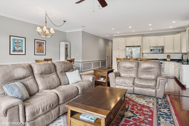 5051 N Clark St Unit 2S, Chicago, IL 60640 - living room featuring crown molding, wood finished floors, ceiling fan, a chandelier, and wainscoting