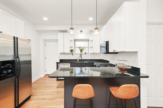 3406 W Medill Ave Unit 1, Chicago, IL 60647 - kitchen featuring stainless steel fridge, a peninsula, light wood finished floors, a kitchen bar, and recessed lighting