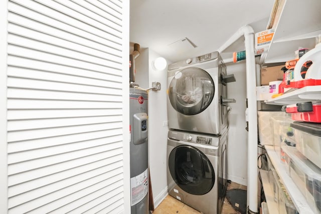 3406 W Medill Ave Unit 1, Chicago, IL 60647 - washroom featuring estacked washer and dryer, baseboards, tile patterned flooring, and water heater