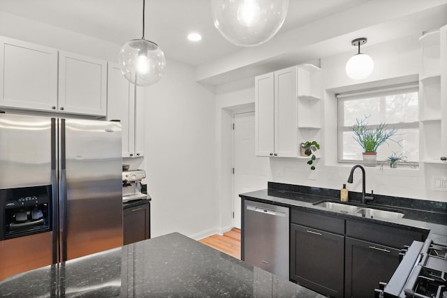 3406 W Medill Ave Unit 1, Chicago, IL 60647 - kitchen featuring appliances with stainless steel finishes, open shelves, a sink, white cabinets, and light wood-style flooring